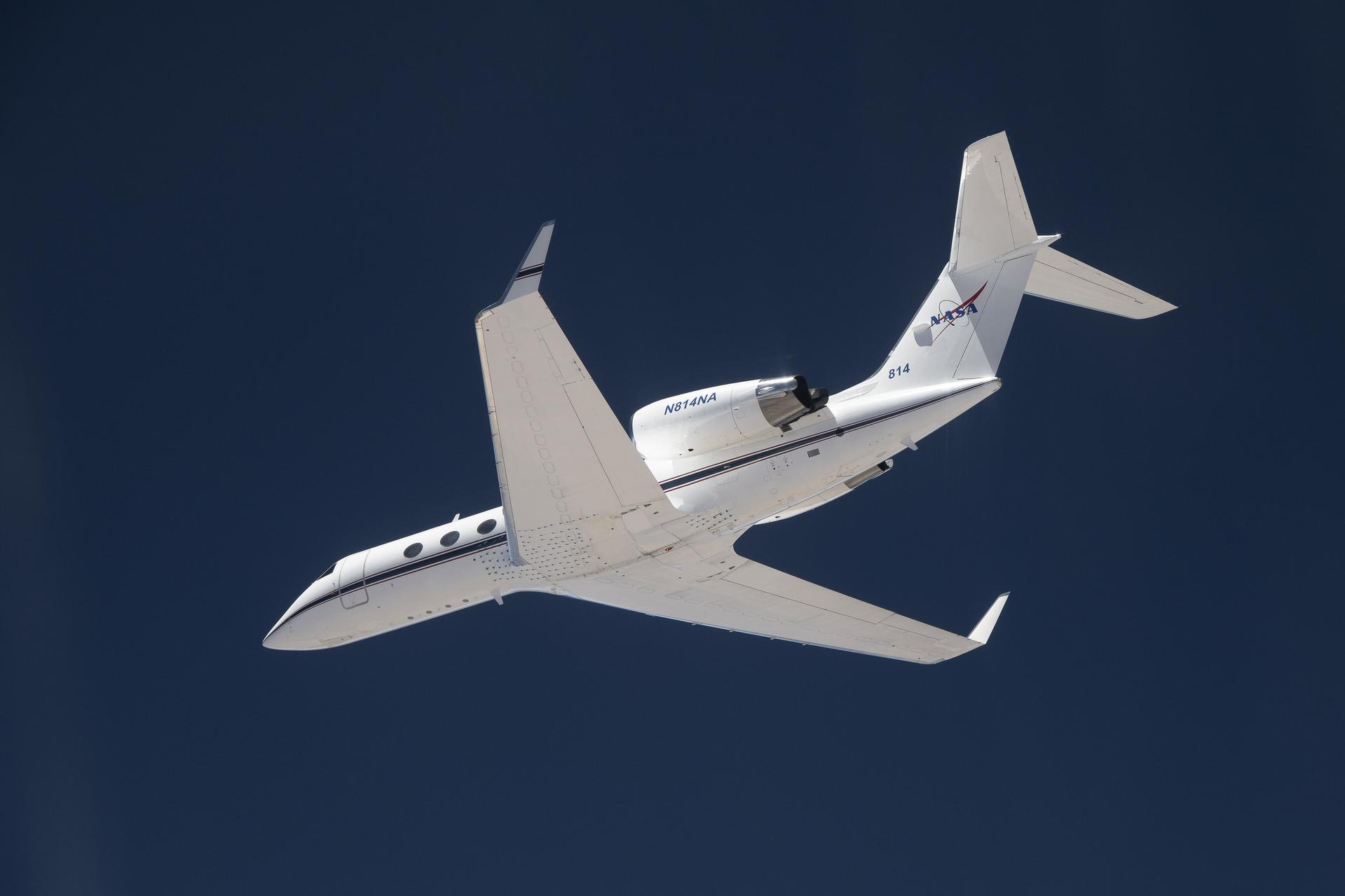 G-IV airplane flying with a background of blue sky